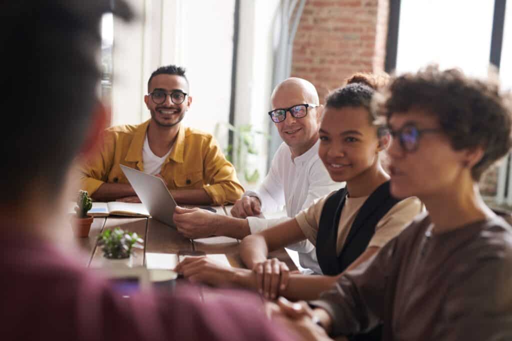 Group of job seekers, sitting around a table, working on their cv