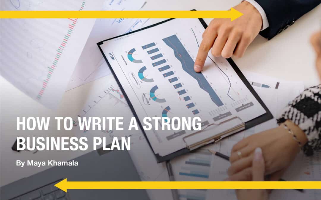 Two yellow arrows go horizontally across the photo's dimensions A hand with a finger points to a photo of a graph The words read "How To Write A Strong Business Plan" written by Maya Khamala