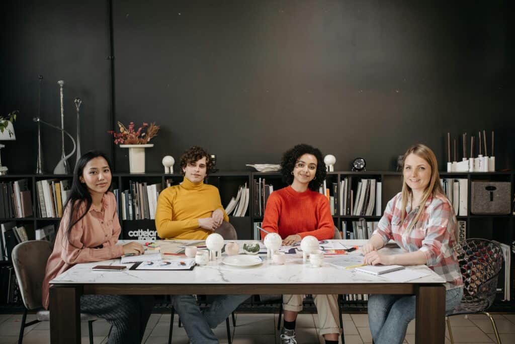 Artists sitting around a table learning about Business Registration 